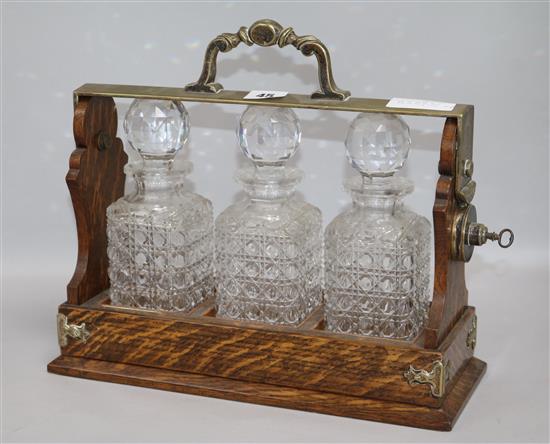 A three bottled tantalus height 31cm width 35cm